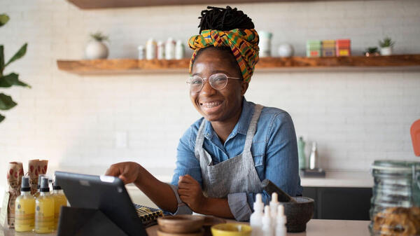 Alumna working the front of a coffee shop